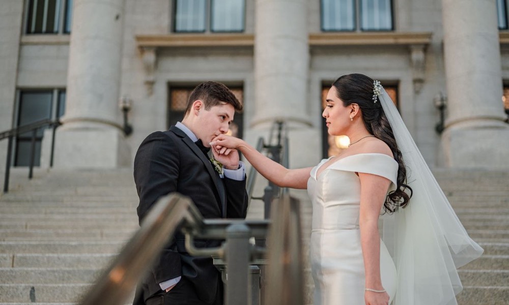 A bride and groom on courthouse steps (stock photo)
